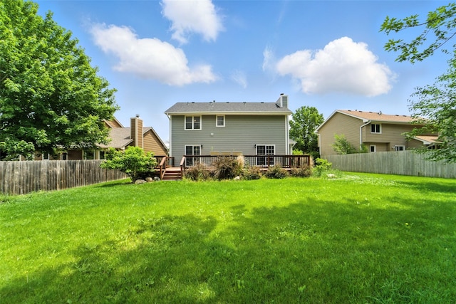 1228 64th St, West Des Moines, IA 50266 - rear view of house with a fenced backyard, a wooden deck, and a chimney