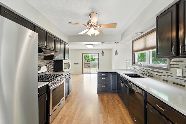 1228 64th St, West Des Moines, IA 50266 - kitchen featuring appliances with stainless steel finishes, under cabinet range hood, a ceiling fan, backsplash, and plenty of natural light