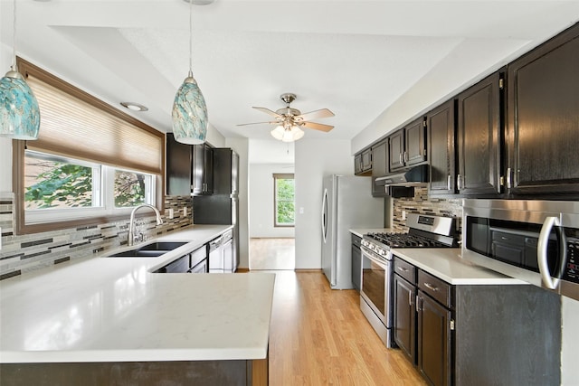 1228 64th St, West Des Moines, IA 50266 - kitchen featuring stainless steel appliances, under cabinet range hood, light countertops, tasteful backsplash, and ceiling fan
