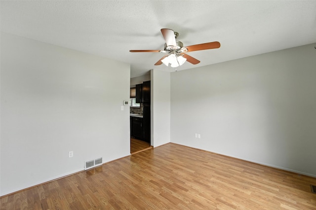 1228 64th St, West Des Moines, IA 50266 - unfurnished room with a ceiling fan and light wood-style flooring