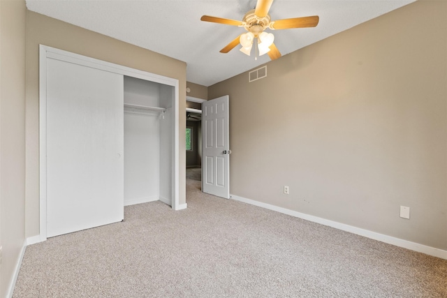 1913 E Bell Ave, Des Moines, IA 50320 - unfurnished bedroom with carpet floors, a closet, and a ceiling fan