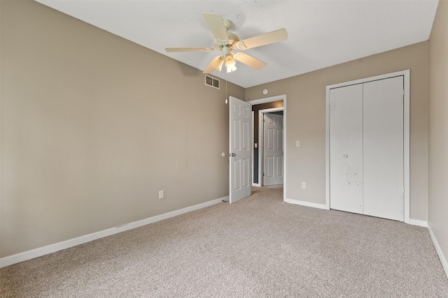 1913 E Bell Ave, Des Moines, IA 50320 - unfurnished bedroom with light colored carpet, a closet, and a ceiling fan