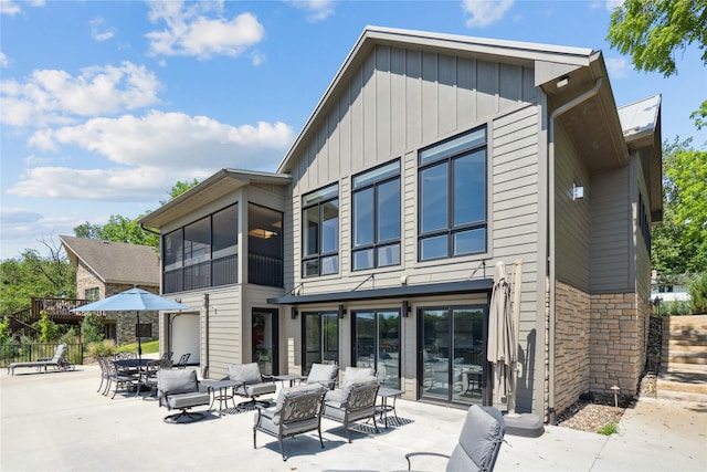 4387 Panorama Dr, Panora, IA 50216 - rear view of property with an outdoor hangout area, a patio, board and batten siding, and stone siding
