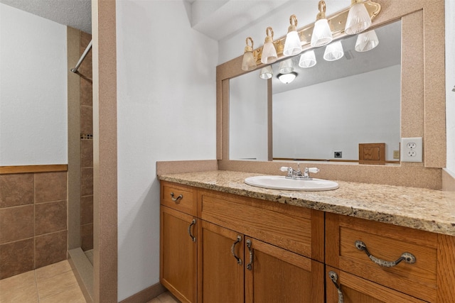 4315 129th St, Urbandale, IA 50323 - bathroom with a tile shower, vanity, and tile patterned flooring