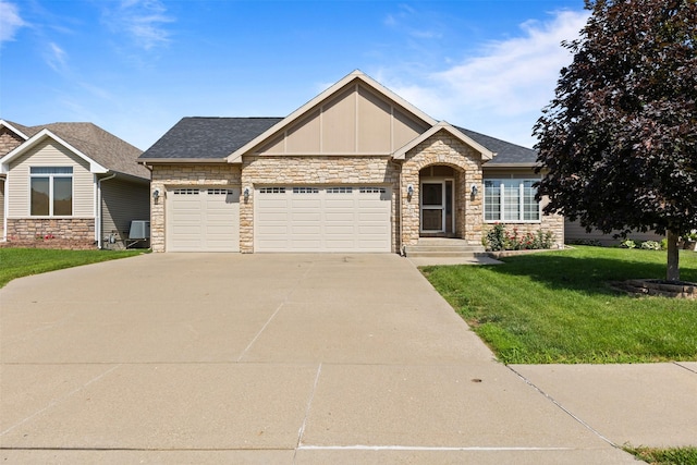 4315 129th St, Urbandale, IA 50323 - view of front of house featuring stone siding, board and batten siding, concrete driveway, a front yard, and a garage