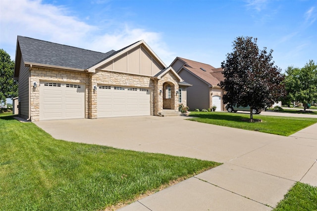 4315 129th St, Urbandale, IA 50323 - view of front of house with stone siding, a garage, driveway, and a front lawn