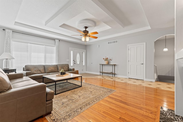 4315 129th St, Urbandale, IA 50323 - living area with a tray ceiling, wood finished floors, and arched walkways