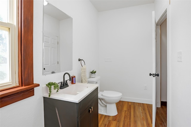 403 E 2nd St S, Newton, IA 50208 - half bathroom featuring vanity and wood finished floors