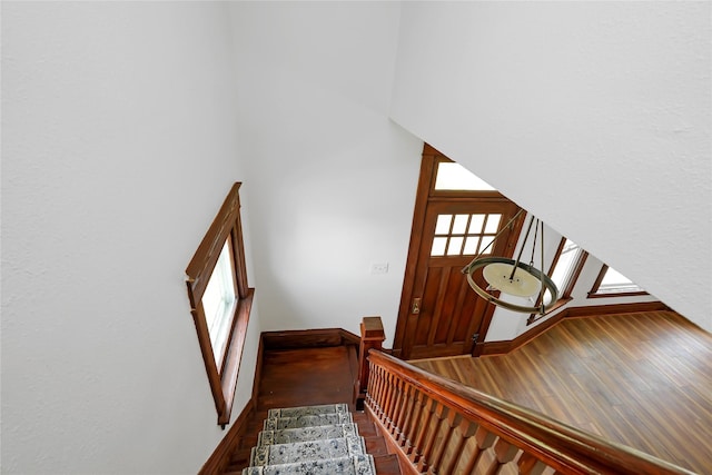 403 E 2nd St S, Newton, IA 50208 - staircase with wood finished floors, healthy amount of natural light, and a high ceiling