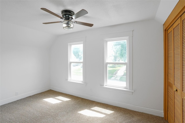 403 E 2nd St S, Newton, IA 50208 - unfurnished bedroom featuring vaulted ceiling, carpet flooring, multiple windows, a closet, and ceiling fan