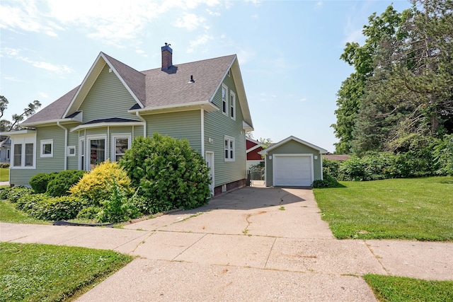 403 E 2nd St S, Newton, IA 50208 - view of side of property with an outdoor structure, concrete driveway, a garage, a lawn, and a chimney