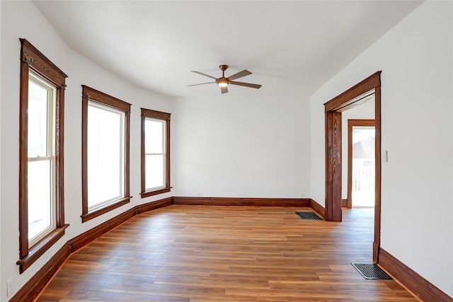 403 E 2nd St S, Newton, IA 50208 - unfurnished room featuring ceiling fan, healthy amount of natural light, and wood finished floors