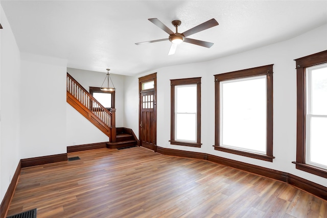 403 E 2nd St S, Newton, IA 50208 - foyer with wood finished floors, stairway, healthy amount of natural light, and ceiling fan