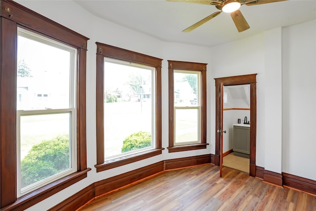 403 E 2nd St S, Newton, IA 50208 - unfurnished room with healthy amount of natural light, light wood-style floors, and a ceiling fan