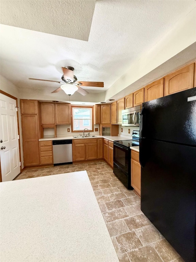 3355 Kinsey Ave, Des Moines, IA 50317 - kitchen with black appliances, a ceiling fan, light countertops, and a textured ceiling