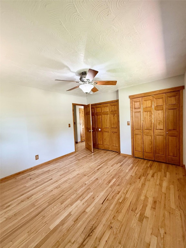 3355 Kinsey Ave, Des Moines, IA 50317 - unfurnished bedroom with light wood-style floors and a ceiling fan
