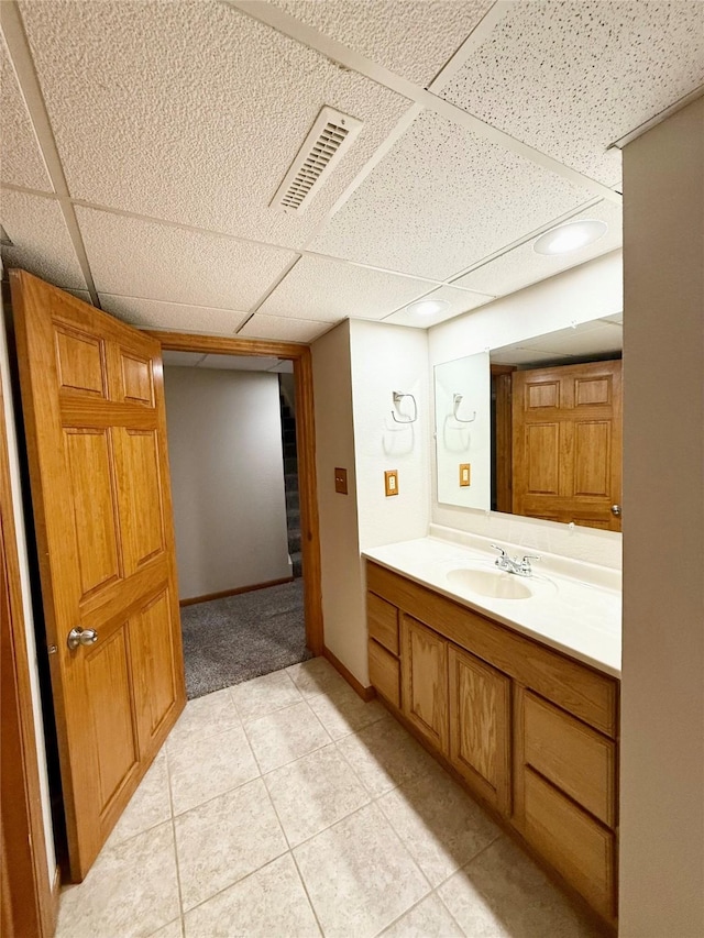 3355 Kinsey Ave, Des Moines, IA 50317 - bathroom featuring a paneled ceiling, vanity, and tile patterned floors
