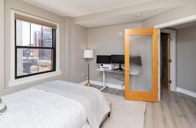 400 Walnut St Unit 901, Des Moines, IA 50309 - bedroom with wood finished floors and baseboards