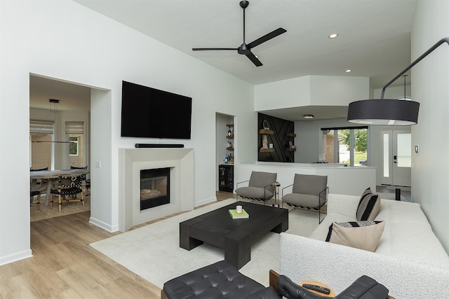1286 Glen Oaks Dr, West Des Moines, IA 50266 - living area with a ceiling fan, wood finished floors, a glass covered fireplace, and recessed lighting