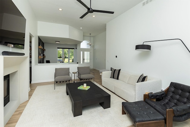 1286 Glen Oaks Dr, West Des Moines, IA 50266 - living room with recessed lighting, ceiling fan, wood finished floors, and a glass covered fireplace