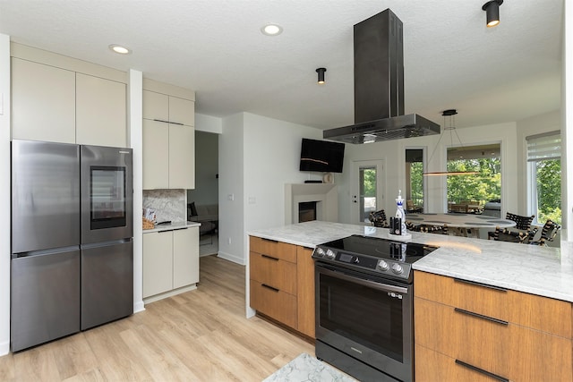 1286 Glen Oaks Dr, West Des Moines, IA 50266 - kitchen with stainless steel appliances, island range hood, modern cabinets, plenty of natural light, and recessed lighting