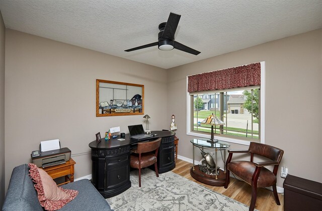 690 SE Driftwood Ln, Waukee, IA 50263 - home office featuring wood finished floors, ceiling fan, and a textured ceiling