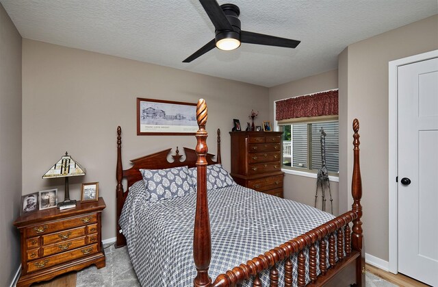 690 SE Driftwood Ln, Waukee, IA 50263 - bedroom with a textured ceiling and ceiling fan