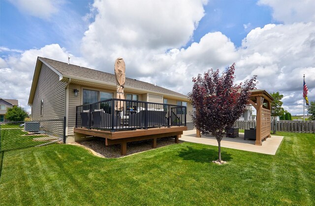 690 SE Driftwood Ln, Waukee, IA 50263 - rear view of house featuring a deck and a patio