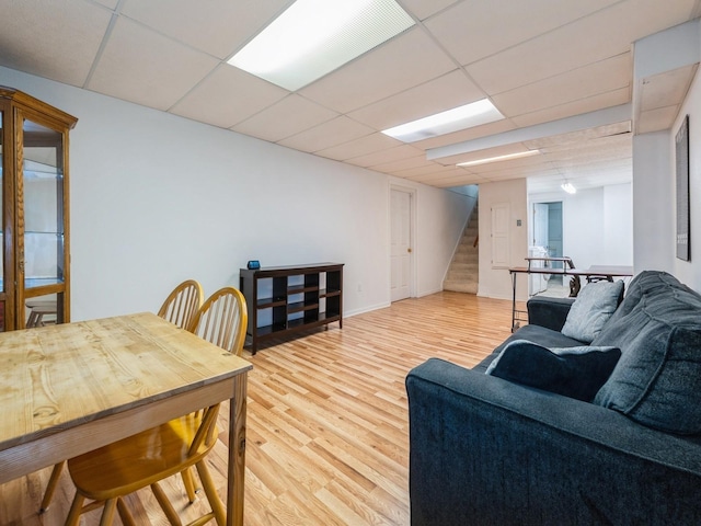 3918 11th St, Des Moines, IA 50313 - living area featuring stairway, light wood-type flooring, and a paneled ceiling