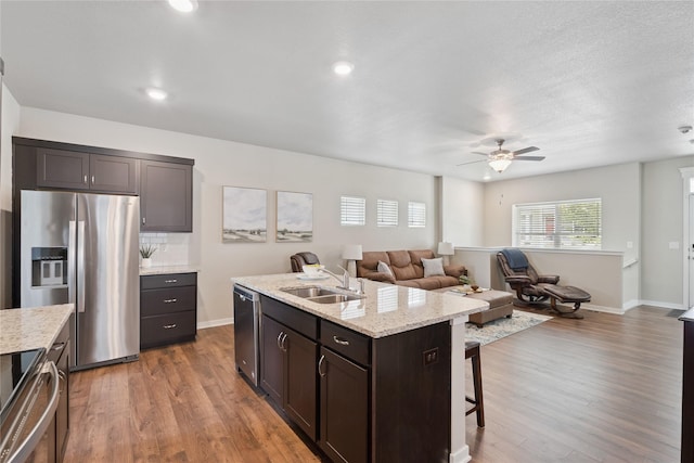 523 S Bluestone Way W, Des Moines, IA 50266 - kitchen featuring appliances with stainless steel finishes, a ceiling fan, wood finished floors, dark brown cabinets, and recessed lighting