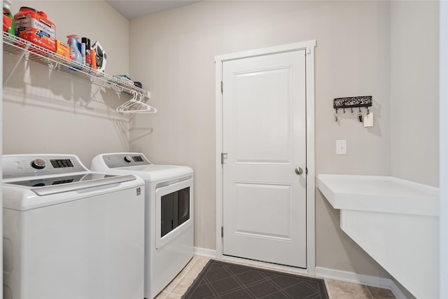 523 S Bluestone Way W, Des Moines, IA 50266 - laundry area with washer and clothes dryer and light tile patterned floors
