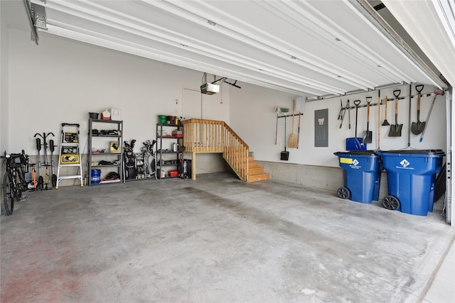 523 S Bluestone Way W, Des Moines, IA 50266 - garage featuring electric panel and a garage door opener