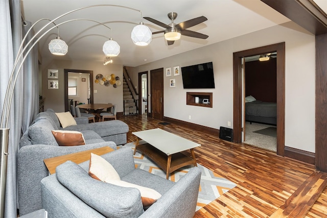 1346 48th St, Des Moines, IA 50311 - living area with ceiling fan, stairway, and wood finished floors