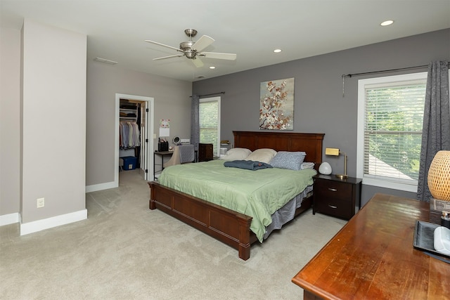 1346 48th St, Des Moines, IA 50311 - bedroom with light colored carpet, a spacious closet, recessed lighting, a ceiling fan, and a closet