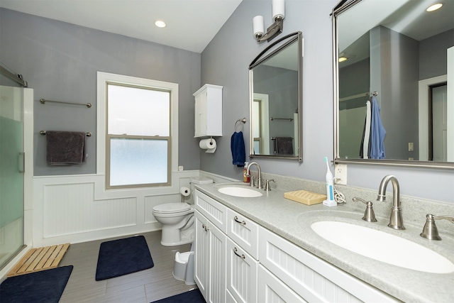 1346 48th St, Des Moines, IA 50311 - full bathroom with wainscoting, an enclosed shower, double vanity, and recessed lighting