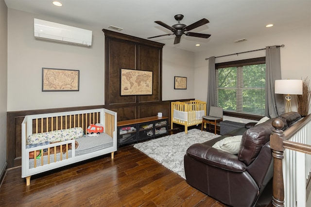1346 48th St, Des Moines, IA 50311 - bedroom with a wall mounted AC, hardwood / wood-style flooring, and recessed lighting