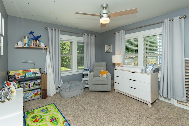 1346 48th St, Des Moines, IA 50311 - bedroom with multiple windows, carpet flooring, and a ceiling fan
