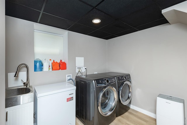 1346 48th St, Des Moines, IA 50311 - washroom with washing machine and clothes dryer, light wood finished floors, and recessed lighting