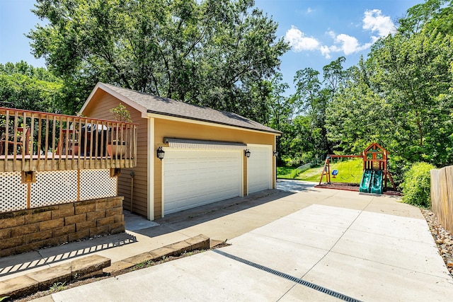 1346 48th St, Des Moines, IA 50311 - garage featuring view of scattered trees