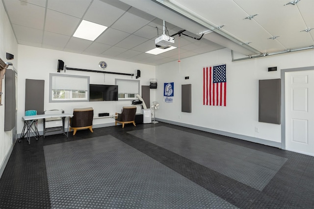 1346 48th St, Des Moines, IA 50311 - garage with a garage door opener and baseboards