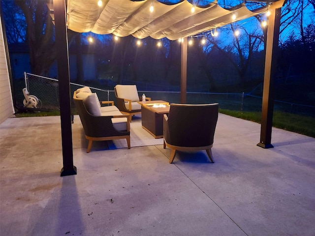 1346 48th St, Des Moines, IA 50311 - patio at night featuring an outdoor fire pit, a pergola, and a patio