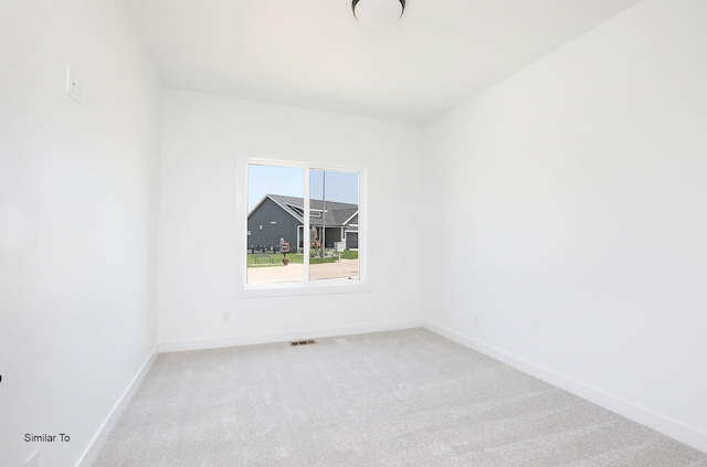 2410 NE 6th St, Grimes, IA 50111 - empty room featuring carpet floors and baseboards