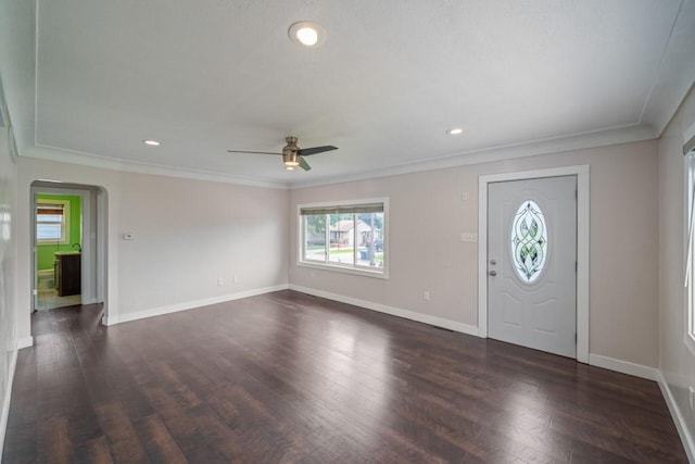 2560 E Sheridan Ave, Des Moines, IA 50317 - foyer entrance featuring arched walkways, dark wood-style flooring, ceiling fan, recessed lighting, and crown molding