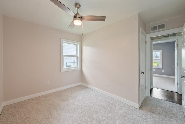 2560 E Sheridan Ave, Des Moines, IA 50317 - unfurnished room with carpet, healthy amount of natural light, and ceiling fan