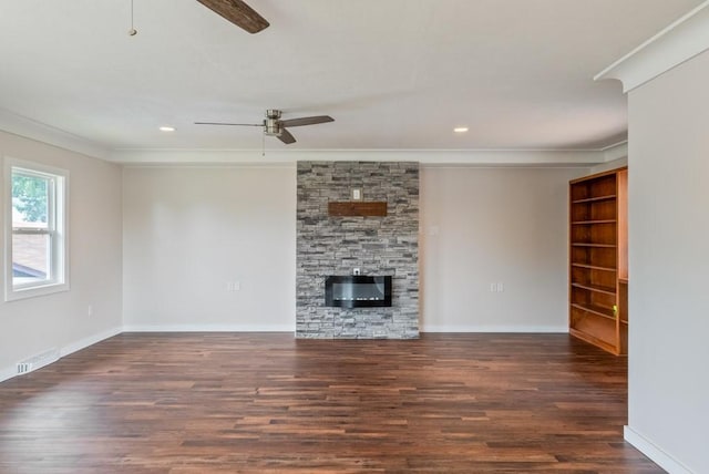 2560 E Sheridan Ave, Des Moines, IA 50317 - unfurnished living room featuring ceiling fan, crown molding, wood finished floors, a stone fireplace, and recessed lighting