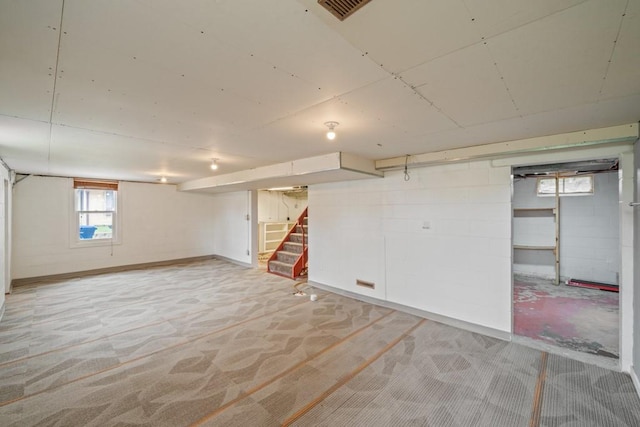2560 E Sheridan Ave, Des Moines, IA 50317 - basement featuring light carpet and stairway