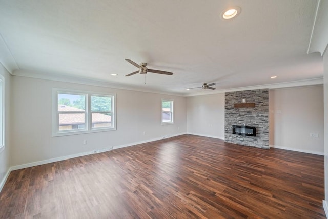 2560 E Sheridan Ave, Des Moines, IA 50317 - unfurnished living room with ornamental molding, a ceiling fan, dark wood-style floors, a fireplace, and recessed lighting