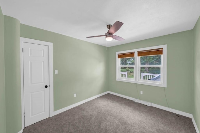 2560 E Sheridan Ave, Des Moines, IA 50317 - carpeted spare room featuring baseboards and ceiling fan