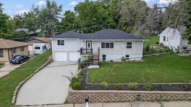2560 E Sheridan Ave, Des Moines, IA 50317 - ranch-style home with a garage, concrete driveway, brick siding, and a shingled roof