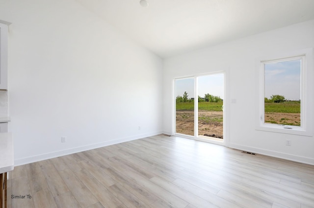 2408 NE 6th St, Grimes, IA 50111 - empty room with light wood-style flooring and baseboards